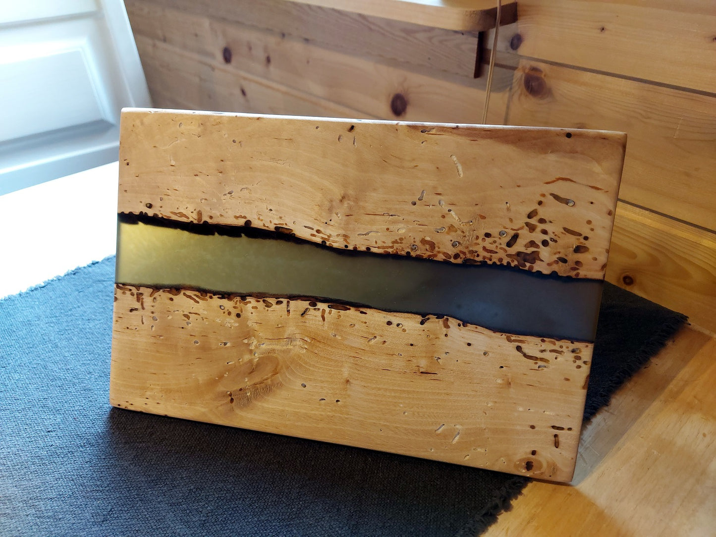 Wooden board in birch and brown epoxy