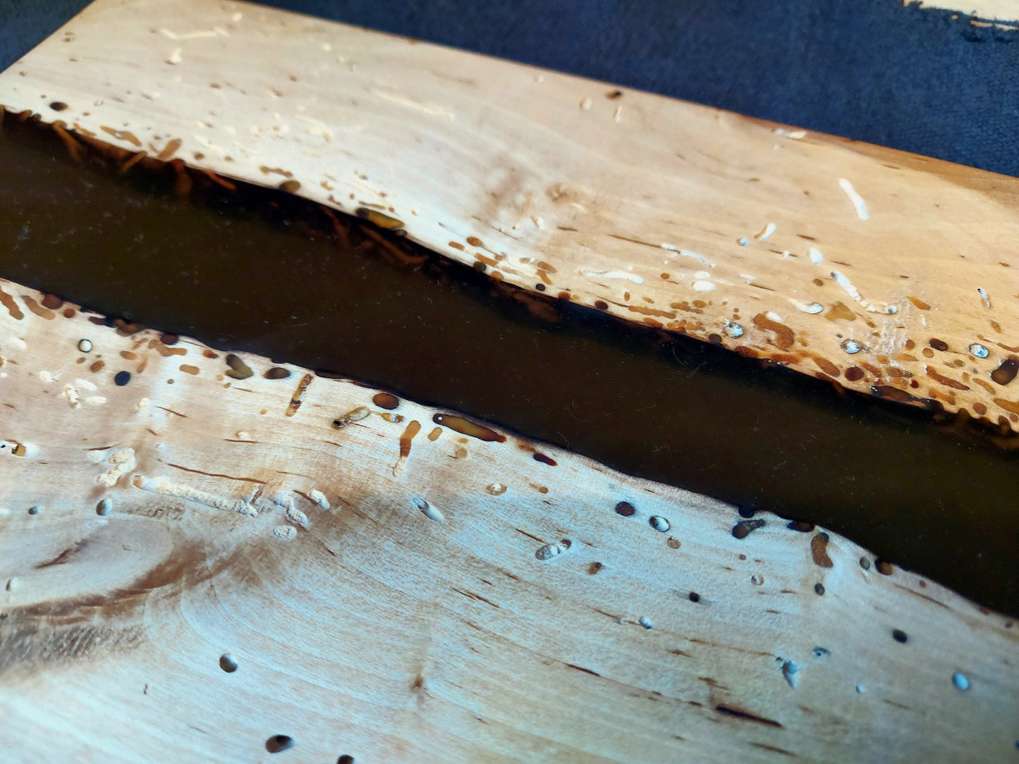 Wooden board in birch and brown epoxy
